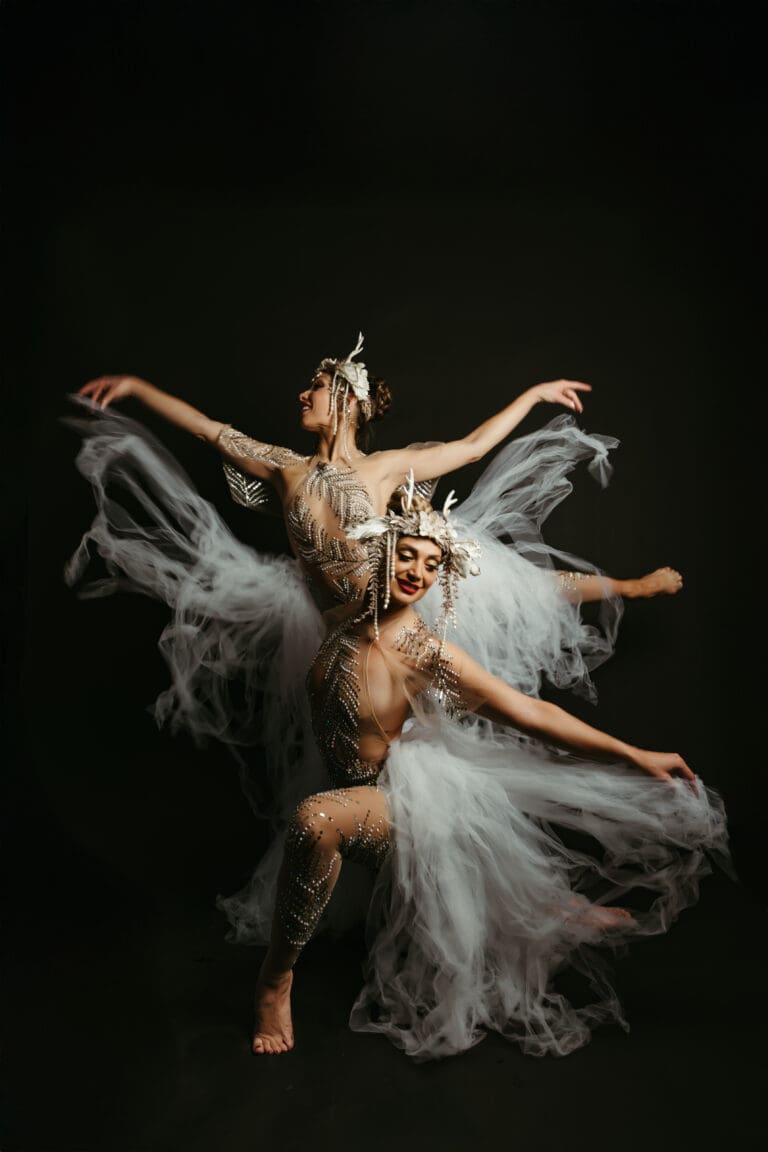 pearl creative two women wearing white dresses and posing for a picture