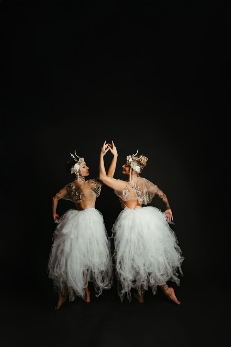 pearl creative two women in white dresses and tiaras